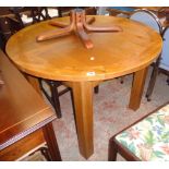 A 3' 7 1/2" diameter 20th Century oak and mixed wood extending dining table with stowed folding leaf