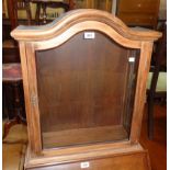 A 22 3/4" stained wood and glazed dome-top display cabinet - with key