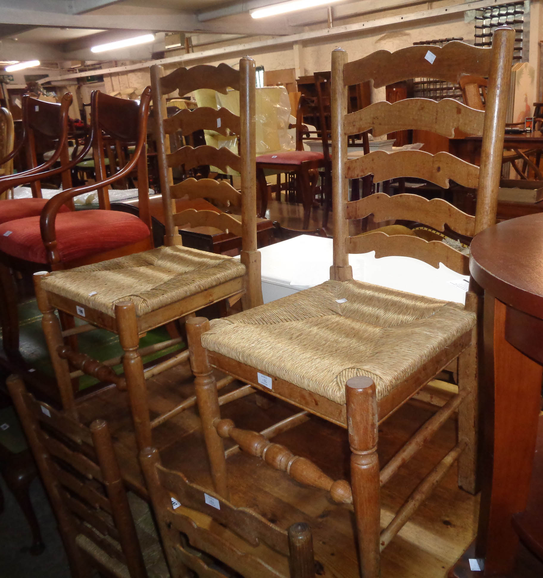 A set of six polished oak framed ladder back dining chairs with woven rush seats, set on turned - Image 2 of 2