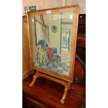 An early 20th Century stained mixed wood framed folding fire screen/tea table with woolwork