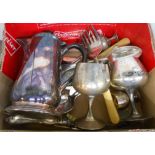 A box containing a quantity of silver plated cutlery, hot water jug, two goblets, etc.