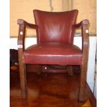 A vintage oak framed office elbow chair upholstered in studded red rexine