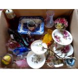 A box containing assorted china and glassware including cranberry glass, Poole dolphin ornament,
