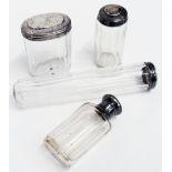 Three silver topped faceted cut glass dressing case bottles and a cologne bottle similar