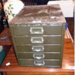 A 10 1/2" vintage green painted metal five drawer table top filing cabinet - top pitted