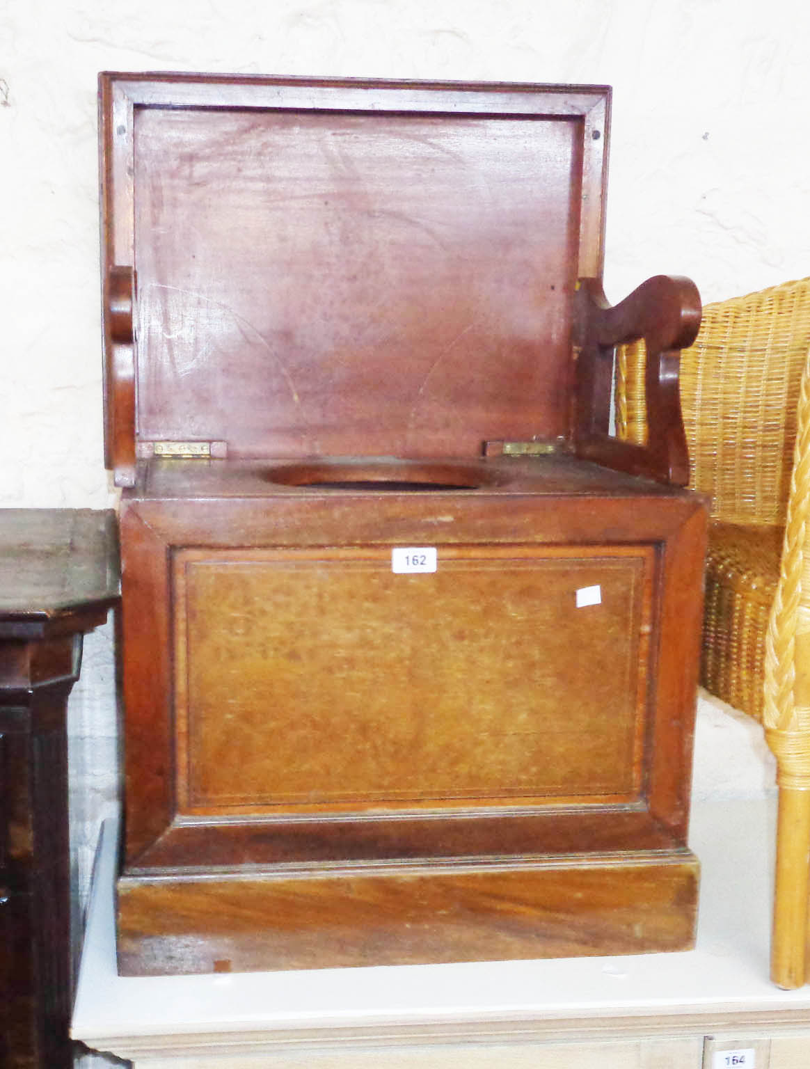 An Edwardian mahogany and strung lift-top box commode with folding armrests