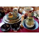 A collection of various pottery pieces including three Colin Kellam plates, drip glaze jug by NC,