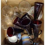 A box containing a set of six Venetian silver overlay glass ruby flutes, three glass cricketers