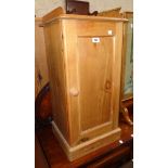 A 15 1/2" waxed pine bedside cabinet with gallery to top and panelled door, set on plinth base