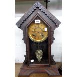 A late 19th Century American stained wood cased shelf clock of architectural design with visible