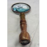 A reproduction magnifying glass with compass to finial