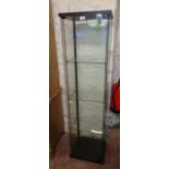 A 16 3/4" modern glazed pedestal display cabinet with three glass shelves and locking door with