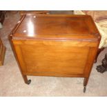 A vintage stained mixed wood two tier tea trolley with sliding drop-leaf top, set on castors