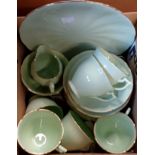 A six place Glade Green bone china part tea set, comprising six trios, bread plate, milk jug and