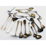 A collection of silver condiment spoons, pair of sugar nips, etc. - various age and makers