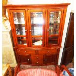 A 4' 10" Mark Webber Furniture "Townsend" range mahogany effect break bow front display cabinet with