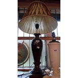A modern carved wood table lamp with shade