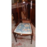 An Art Nouveau inlaid walnut framed bedroom chair with upholstered seat panel