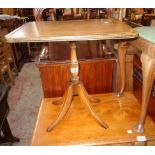 A reproduction mahogany tilt-top pedestal wine table, set on turned pillar and quadruple splayed