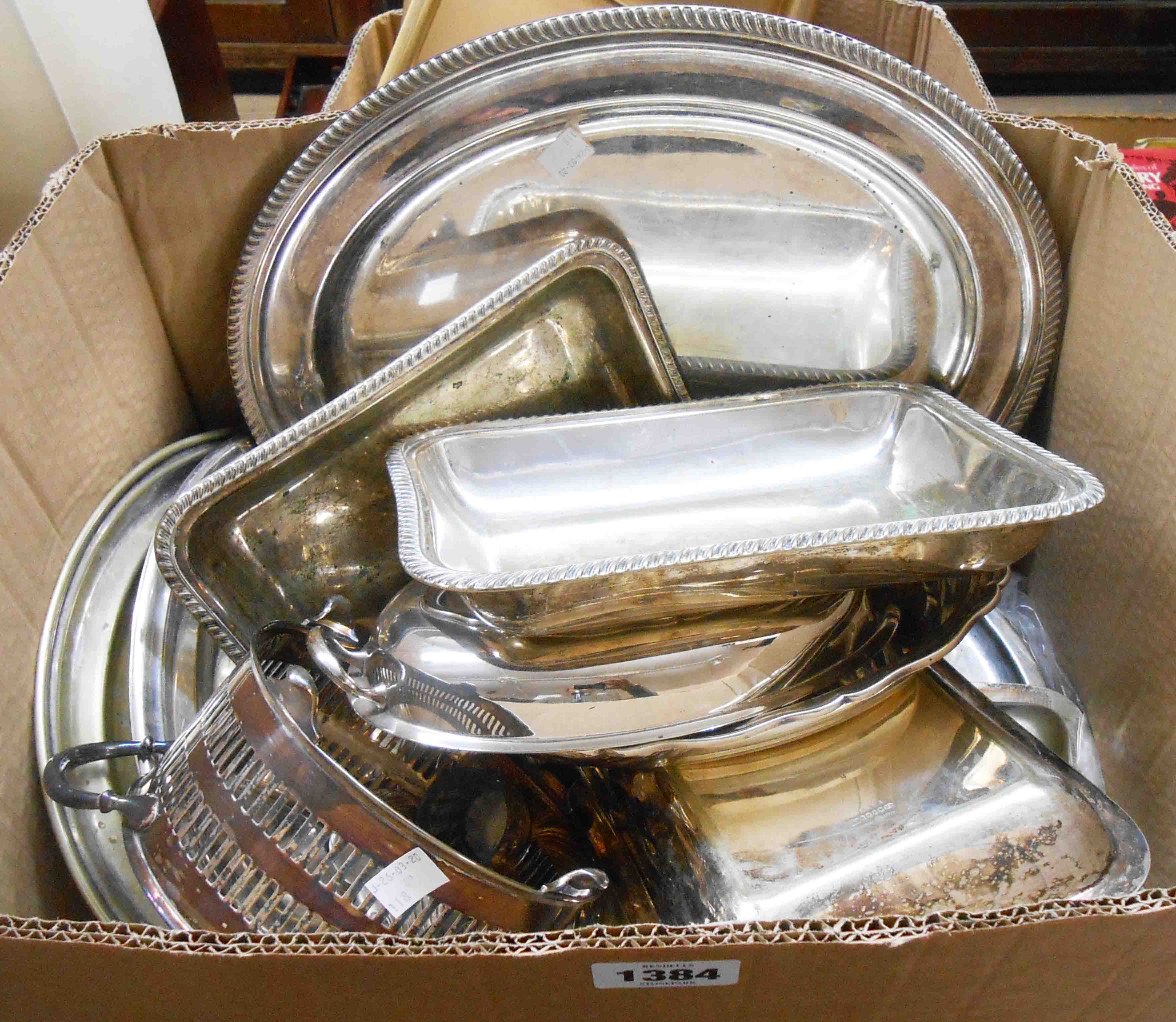 A box containing a quantity of silver plated items including entree dishes, trays, etc.
