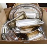 A box containing a quantity of silver plated items including entree dishes, trays, etc.