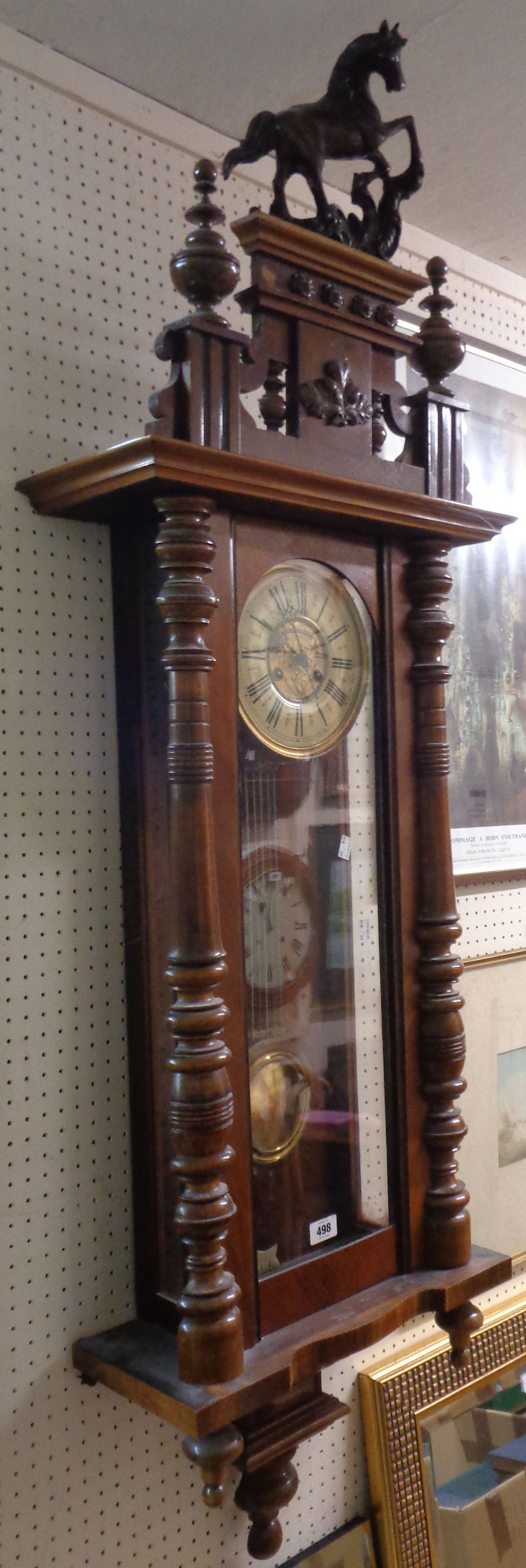 A large early 20th Century walnut cased Vienna style regulator wall clock with ornate cast horse