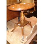 A 17" reproduction mahogany and mixed wood pedestal table with oval top, set on turned pillar and