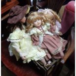 A large modern porcelain doll sat in a chair - sold with two others