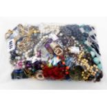 A bag containing a quantity of assorted costume jewellery