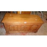 A 3' 1 1/2" 20th Century polished oak blanket chest with triple linen-fold panels to front, set on