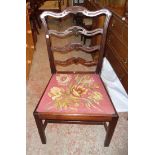 An antique provincial mahogany framed ladder back standard chair with pierced decoration and drop-in