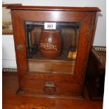 A 11 1/2" early 20th Century polished oak and metal mounted smoker's cabinet with fitted interior