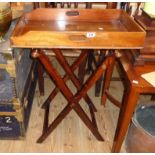 An Edwardian mahogany butler's tray, set on an associated folding on stand