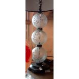 A pair of modern glass ball form table lamps