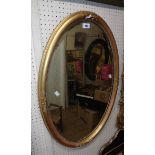 A 32" antique gilt gesso framed bevelled oval mirror - slight damage