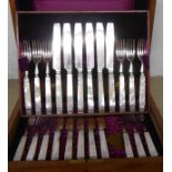 A polished oak cased part set of Art Deco silver plated dessert knives and forks with mother-of-