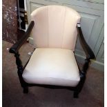 A 1930`s stained wood framed tub elbow chair with later cream coloured leather upholstery
