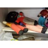 A vintage musical Golly doll - sold with a knitted example and another