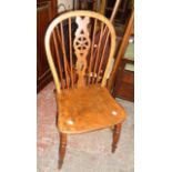 An antique wheel back kitchen chair with solid elm seat, set on ring turned supports - sold with