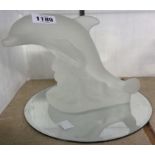 A moulded frosted glass model of a leaping dolphin on mirror base