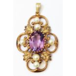 A hallmarked 375 gold Edwardian style open scroll pendant, set with central oval amethyst and seed