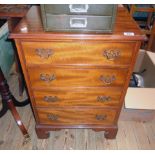 A 21" early 20th Century mahogany chest of four long graduated drawers, set on bracket feet