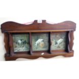 An early 20th Century walnut shelf rack with three sections decorated with humorous images of