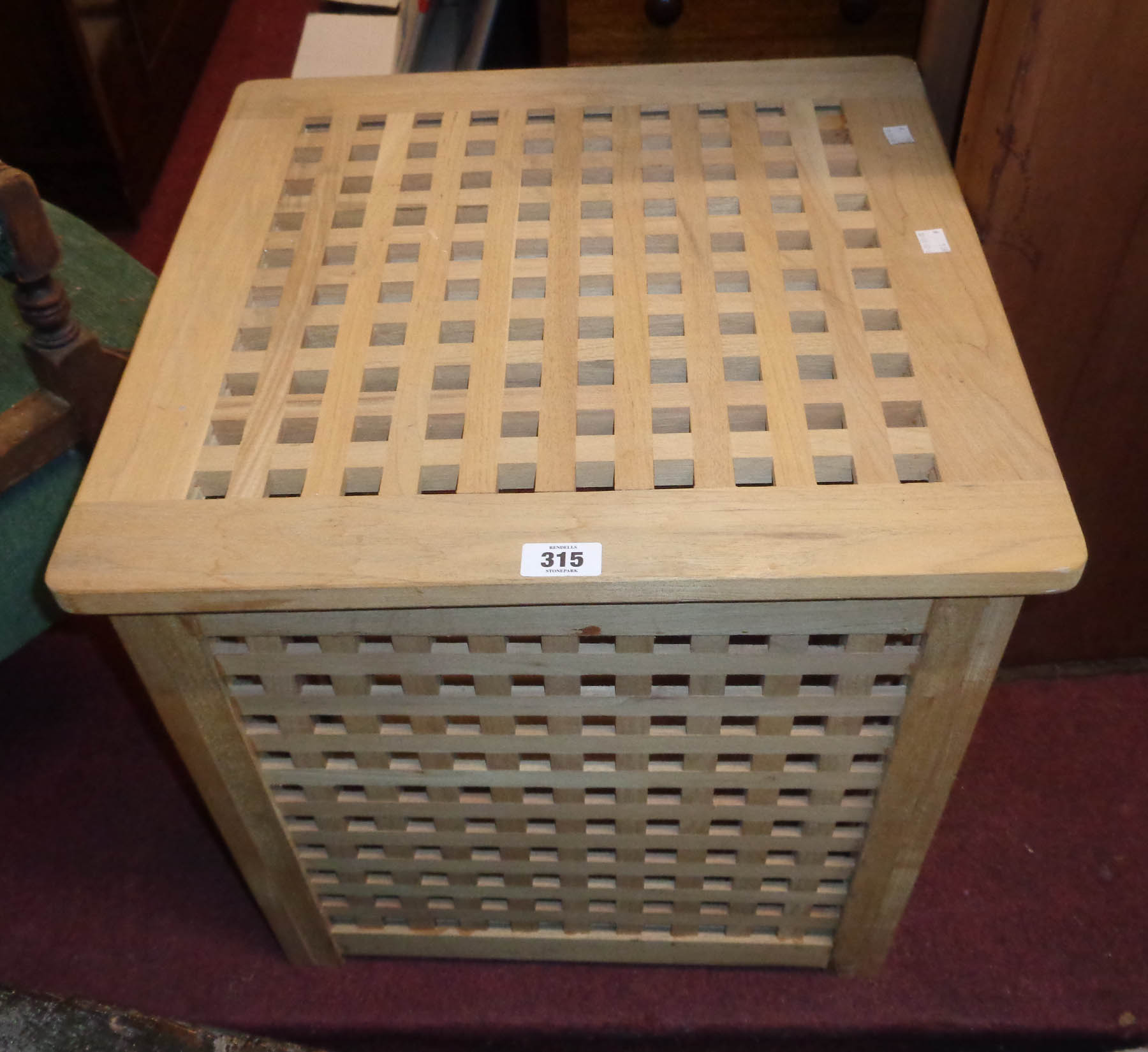 A modern hardwood laundry basket of lattice design