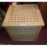 A modern hardwood laundry basket of lattice design