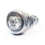 A 1970`s import marked 750 white gold diamond solitaire gentleman's ring with bark effect finish -