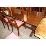 A 6' 20th Century polished oak refectory table with thick solid top, set on flanking massive bulbous