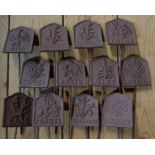 A set of twelve cast iron herb labels