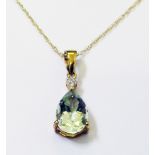 An import marked 375 gold pendant, set with pale green/blue quartz pear cut stone and tiny