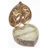 A 5 3/4" marked Sterling heart shaped jewellery box with embossed foliate scroll decoration,